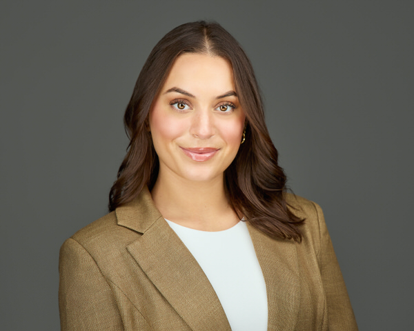 headshots san diego | women in blazer in front of dark grey backdrop